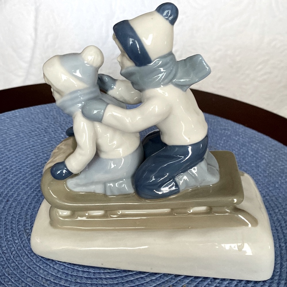 1992 Ceramic Made in Mexico. Two children on sled.